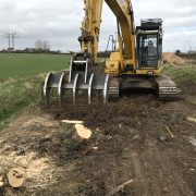Root rake clearing tree stumps