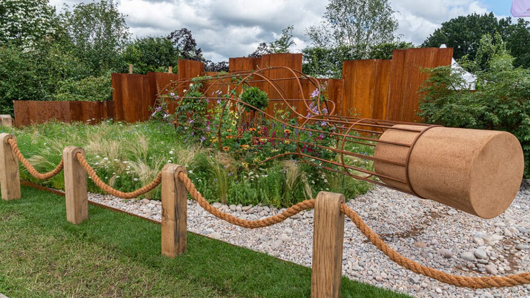 Award winning design from Tracy Foster at Hampton Court Garden Festival featuring a giant metal framed bottle containing a beautiful garden